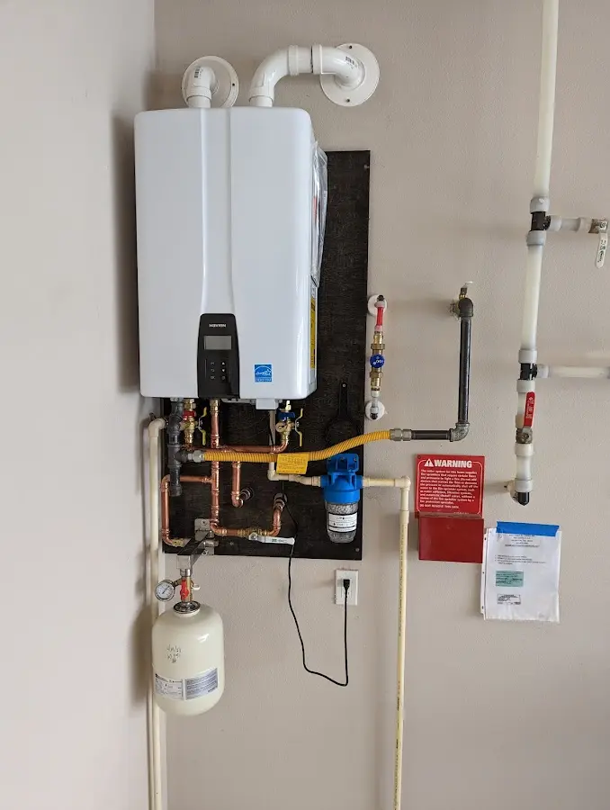 Professional plumber installing copper piping in a Fillmore home